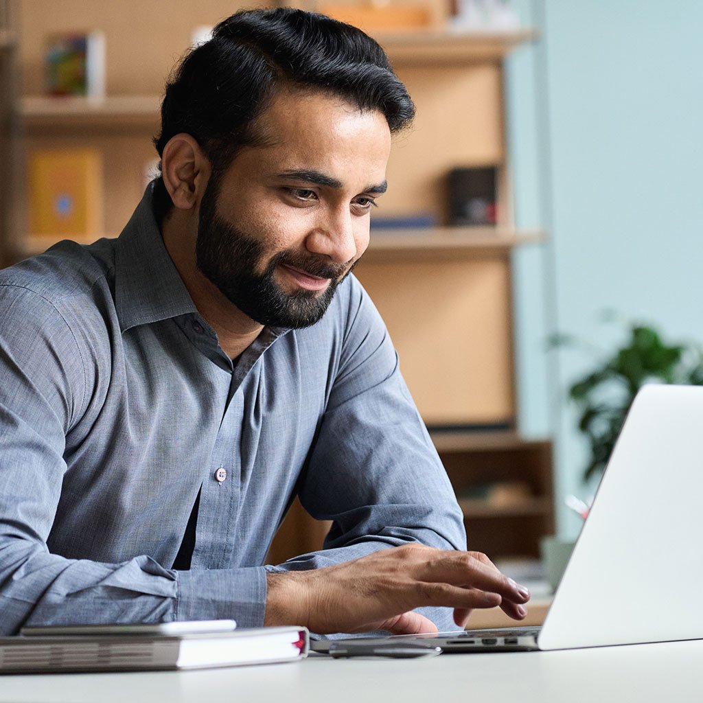 Smiling man representing Tharwatalwatan’s Enhanced Plus or Comprehensive Health Plan for corporate clients